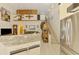 Open-concept living room features white cabinets with stone counters, stairs, and unique decorative touches at 127 Colonial Sw St, Port Charlotte, FL 33952