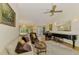 Cozy living room with a grand piano, plush seating, and an open layout at 127 Colonial Sw St, Port Charlotte, FL 33952