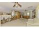 Open living room featuring display cabinets, a couch, and a view of the upper floor at 127 Colonial Sw St, Port Charlotte, FL 33952