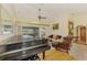 Spacious living room with high ceilings, a grand piano, and comfortable seating at 127 Colonial Sw St, Port Charlotte, FL 33952