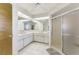 White-painted bathroom with dual sinks, white cabinets, and a glass enclosed walk-in shower at 127 Colonial Sw St, Port Charlotte, FL 33952