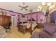 Purple-painted bedroom featuring a canopy bed, wood floors, and custom decor at 127 Colonial Sw St, Port Charlotte, FL 33952