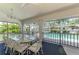 Enclosed patio features dining table and chairs with views of the pool at 127 Colonial Sw St, Port Charlotte, FL 33952