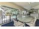 Enclosed patio with dining table and water view in backyard of home at 127 Colonial Sw St, Port Charlotte, FL 33952