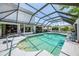 Enclosed pool with a water view from the backyard of the home at 127 Colonial Sw St, Port Charlotte, FL 33952