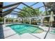 Enclosed pool offers sunny enjoyment with landscaping and canal views at 127 Colonial Sw St, Port Charlotte, FL 33952