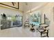 Bright sunroom with pool view featuring tile flooring and ample natural light at 127 Colonial Sw St, Port Charlotte, FL 33952
