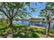 Lush waterfront view showcasing the boat lift ready for your boat in the beautiful channel at 127 Colonial Sw St, Port Charlotte, FL 33952