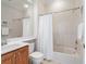 Clean bathroom with a tub, shower, white tile, and a wood vanity at 1313 Thornapple Dr, Osprey, FL 34229