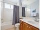 Bright bathroom features a tub/shower combo and a vanity with wood cabinetry at 1313 Thornapple Dr, Osprey, FL 34229