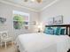 Bright bedroom featuring a comfortable bed, fresh white walls, and sunny window at 1313 Thornapple Dr, Osprey, FL 34229