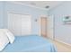 Light blue bedroom features a closet, minimalist decor, and a comfortable queen bed at 1313 Thornapple Dr, Osprey, FL 34229