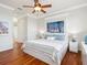 Stylish bedroom with hardwood floors, beachy decor, and a ceiling fan for comfortable living at 1313 Thornapple Dr, Osprey, FL 34229