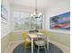 Bright breakfast nook with colorful chairs and a large window at 1313 Thornapple Dr, Osprey, FL 34229