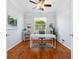 Bright home office with hardwood floors, a modern desk and a ceiling fan at 1313 Thornapple Dr, Osprey, FL 34229