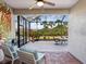 Inviting screened patio with comfortable seating and a view of the landscaped yard at 1313 Thornapple Dr, Osprey, FL 34229