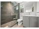 Modern bathroom featuring a glass shower, marble backsplash, and gray vanity at 1365 Harbor Dr, Sarasota, FL 34239