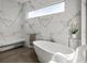Modern bathroom features a white bathtub and marble tiling at 1365 Harbor Dr, Sarasota, FL 34239
