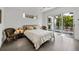 Bright bedroom features a cozy bed, seating, and sliding glass door to the outdoor pool area at 1365 Harbor Dr, Sarasota, FL 34239