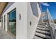 Modern exterior with white stucco, stainless steel stair railing, and a glass slider door at 1365 Harbor Dr, Sarasota, FL 34239