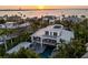 Modern home with balconies and a pool, set against a picturesque waterfront view at sunset at 1365 Harbor Dr, Sarasota, FL 34239