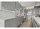 The kitchen features a sleek design with gray cabinets, stainless steel appliances, and modern countertops at 1365 Harbor Dr, Sarasota, FL 34239