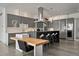 Modern kitchen features sleek gray cabinetry, waterfall countertops, stainless steel appliances and seating at the island at 1365 Harbor Dr, Sarasota, FL 34239