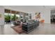 The living area showcases large glass doors that blend indoor and outdoor living spaces, and contemporary furnishings at 1365 Harbor Dr, Sarasota, FL 34239