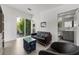 Living room featuring a sliding glass door, modern furniture, and access to a full bathroom at 1365 Harbor Dr, Sarasota, FL 34239