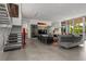 A spacious living room featuring sleek tile flooring, modern furniture, and an open staircase at 1365 Harbor Dr, Sarasota, FL 34239