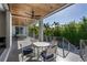 This expansive outdoor living area features lush palm trees, sleek patio furniture, and elegant covered seating at 1365 Harbor Dr, Sarasota, FL 34239