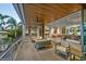 An expansive patio with stylish seating, an open flow into the main living space, and lush landscaping at 1365 Harbor Dr, Sarasota, FL 34239