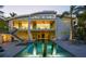 Expansive backyard featuring a modern home, beautiful pool with fountains, and ample lounge space at 1365 Harbor Dr, Sarasota, FL 34239
