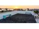 Spacious rooftop deck with modern benches overlooking a bay at sunset at 1365 Harbor Dr, Sarasota, FL 34239