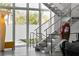 Modern staircase with metal railings, large windows, and decorative accents at 1365 Harbor Dr, Sarasota, FL 34239
