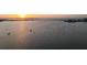 Sunset over water, the horizon line shows sailboats and a bridge at 1365 Harbor Dr, Sarasota, FL 34239