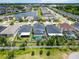An aerial view showcases the home, pool, and surrounding neighborhood by a pond at 14363 59Th E Cir, Lakewood Ranch, FL 34211