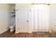 Bright bathroom featuring a toilet and a shower with a curtain; a fresh space at 14363 59Th E Cir, Lakewood Ranch, FL 34211