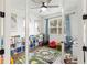 Bright playroom featuring a ceiling fan, laminate flooring, and neatly organized toy storage at 14363 59Th E Cir, Lakewood Ranch, FL 34211