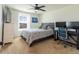 Bright bedroom with modern ceiling fan, neutral carpet, desk and chair at 14363 59Th E Cir, Lakewood Ranch, FL 34211