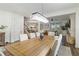 Spacious dining room showcases modern chandelier, abundant seating, and open-concept living at 14363 59Th E Cir, Lakewood Ranch, FL 34211