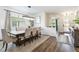 Bright dining room features modern chandelier, ample seating, and flows into other living spaces at 14363 59Th E Cir, Lakewood Ranch, FL 34211
