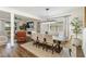 Bright dining room boasts modern lighting, an accent brick wall, and a seamless flow to the living area at 14363 59Th E Cir, Lakewood Ranch, FL 34211