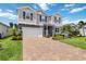 Two-story home with well-maintained lawn, paver driveway, and symmetrical design at 14363 59Th E Cir, Lakewood Ranch, FL 34211