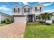 Charming two-story home with manicured lawn and paver driveway provides great curb appeal at 14363 59Th E Cir, Lakewood Ranch, FL 34211