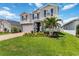 Attractive two-story home with lush lawn, palm tree, and inviting curb appeal at 14363 59Th E Cir, Lakewood Ranch, FL 34211
