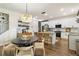 Bright, open kitchen boasts stainless appliances, a large island with bar seating, and modern pendant lighting at 14363 59Th E Cir, Lakewood Ranch, FL 34211