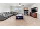 Spacious living room with comfortable seating, a ceiling fan, and natural light at 14363 59Th E Cir, Lakewood Ranch, FL 34211