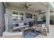 Outdoor patio space with comfortable seating, ceiling fans, and a TV at 14363 59Th E Cir, Lakewood Ranch, FL 34211