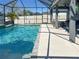 Inviting screened pool with a tiled trim and covered patio area at 14363 59Th E Cir, Lakewood Ranch, FL 34211